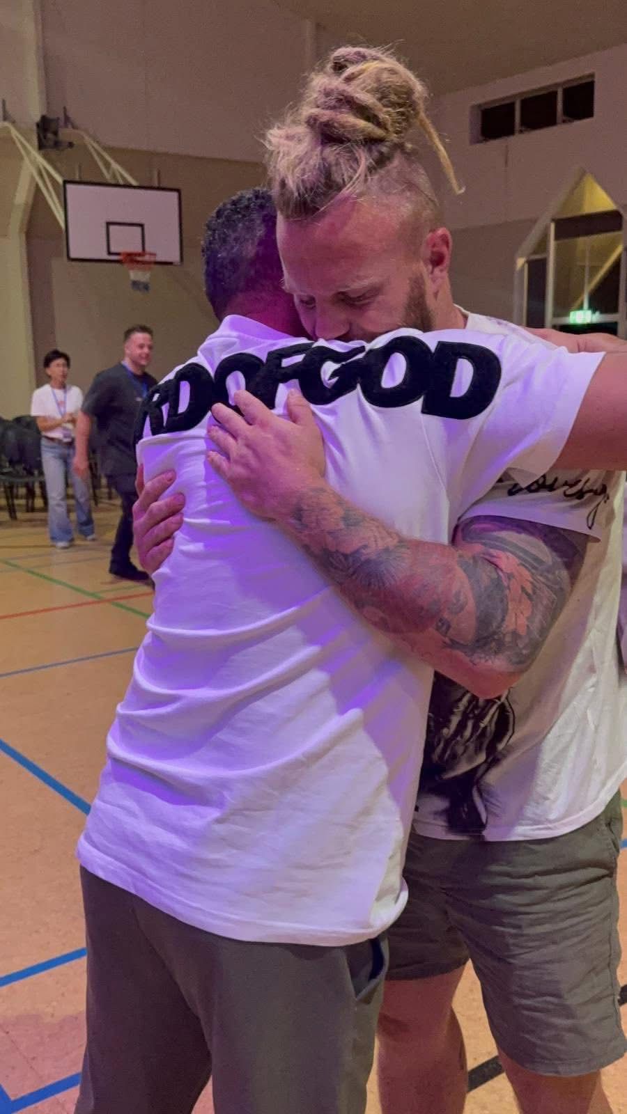 Members of the TSNL Melbourne family embracing after a Saturday service
