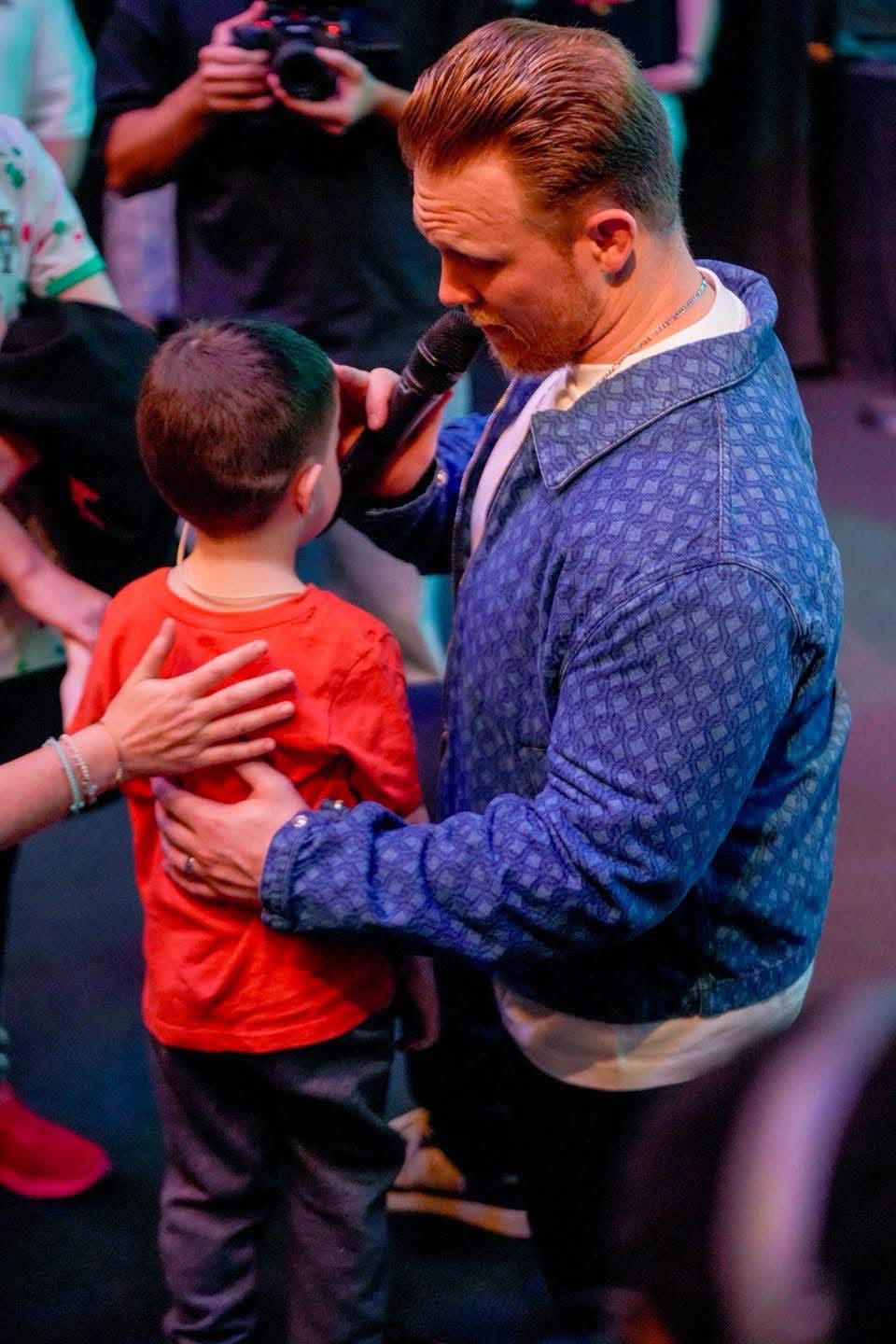 Praying with a child at a TSNL Church Melbourne revival service