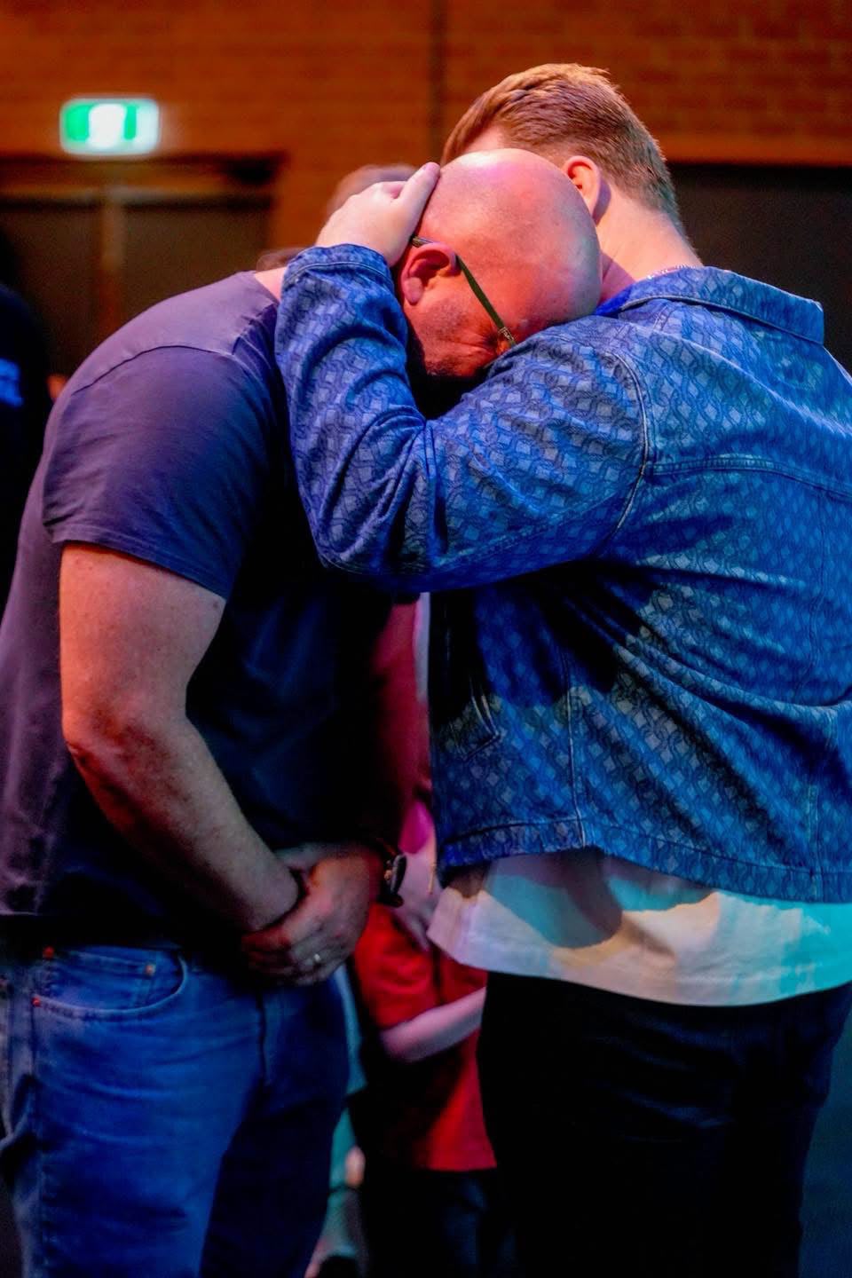 Praying together at a TSNL Church Melbourne revival service