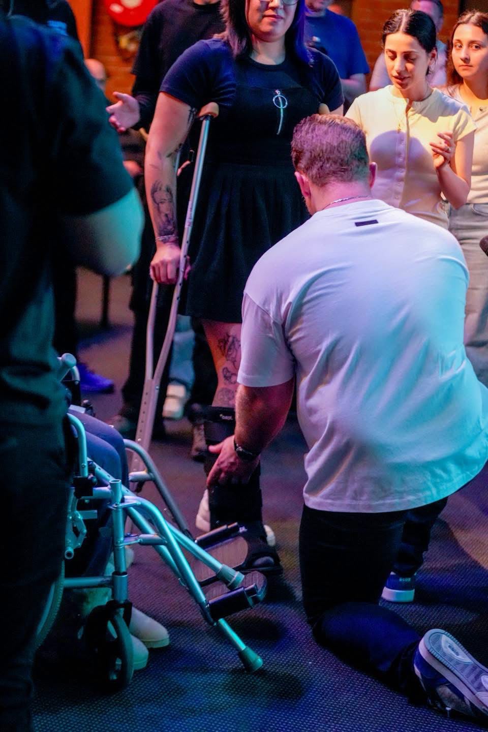 Kneeling in prayer at a TSNL Church Melbourne revival service